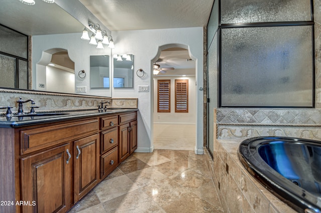 bathroom featuring double sink, oversized vanity, tile flooring, tasteful backsplash, and ceiling fan