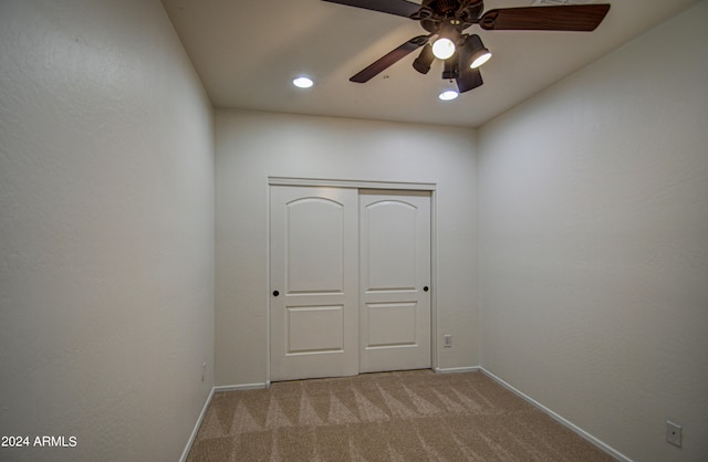 carpeted empty room with ceiling fan