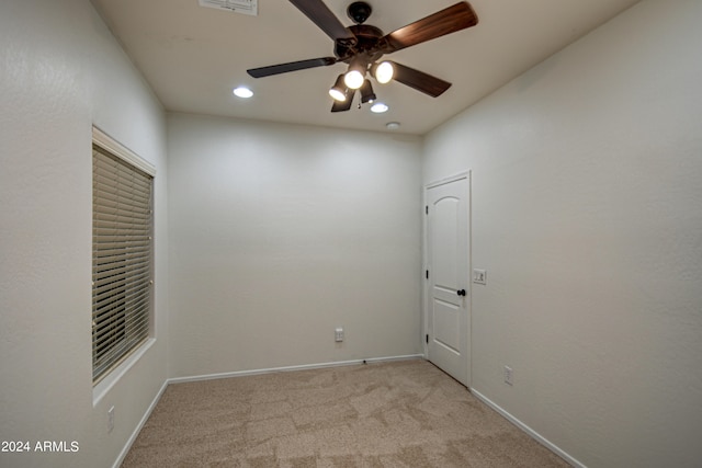 carpeted empty room featuring ceiling fan