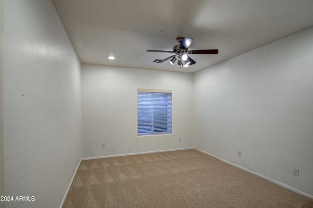 carpeted empty room featuring ceiling fan