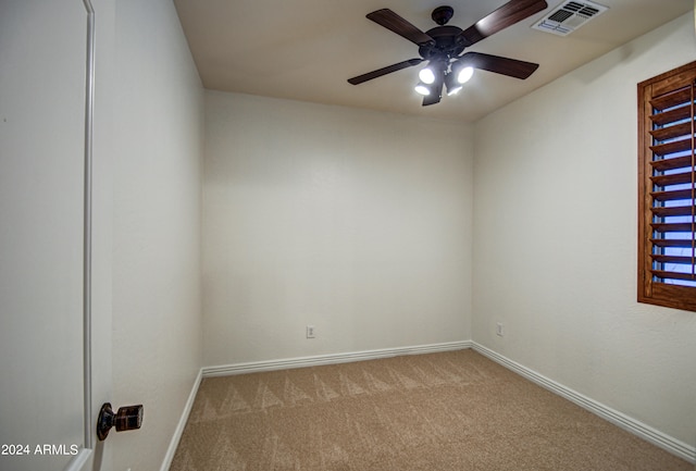 spare room featuring carpet floors and ceiling fan