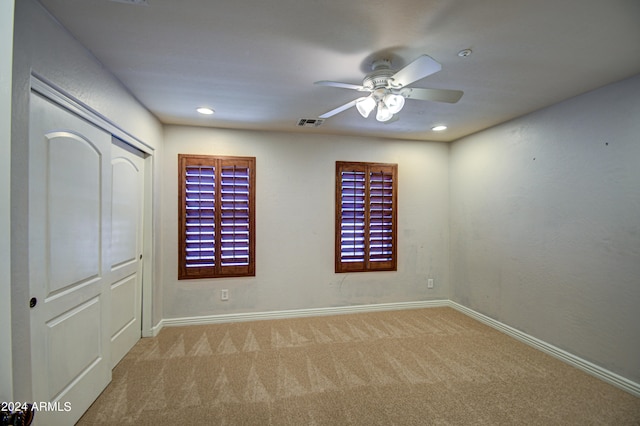 spare room featuring ceiling fan and carpet