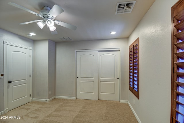 hallway featuring light colored carpet