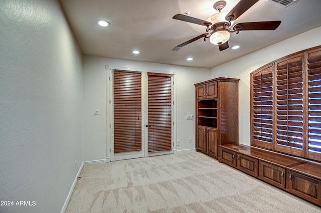 carpeted spare room featuring ceiling fan