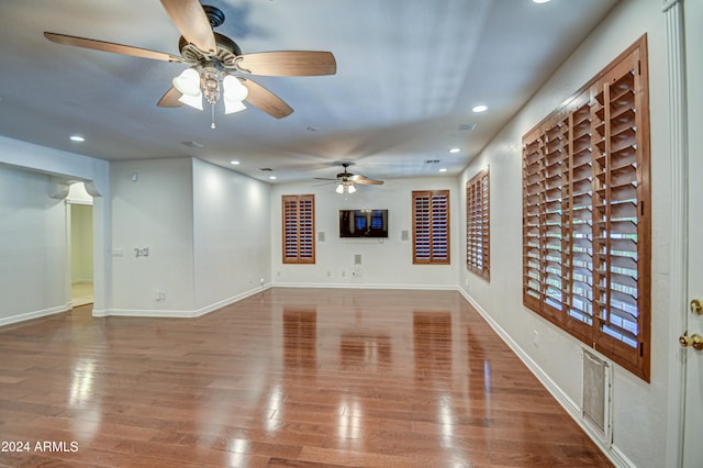 unfurnished living room featuring wood-type flooring and ceiling fan