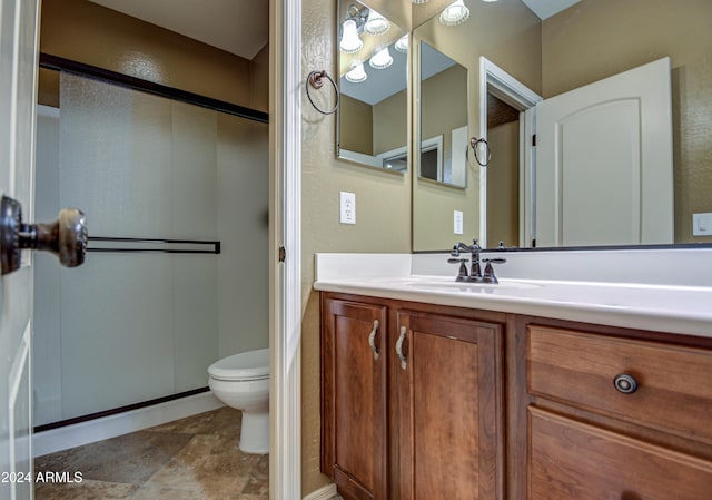 bathroom with an enclosed shower, toilet, tile floors, and vanity