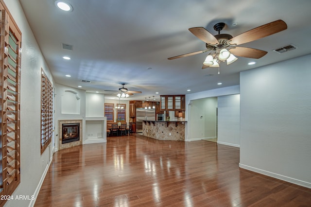 unfurnished living room with hardwood / wood-style flooring and ceiling fan