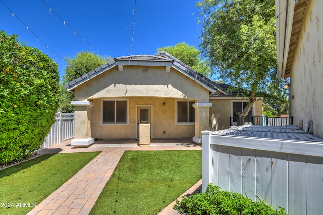 back of house with a yard