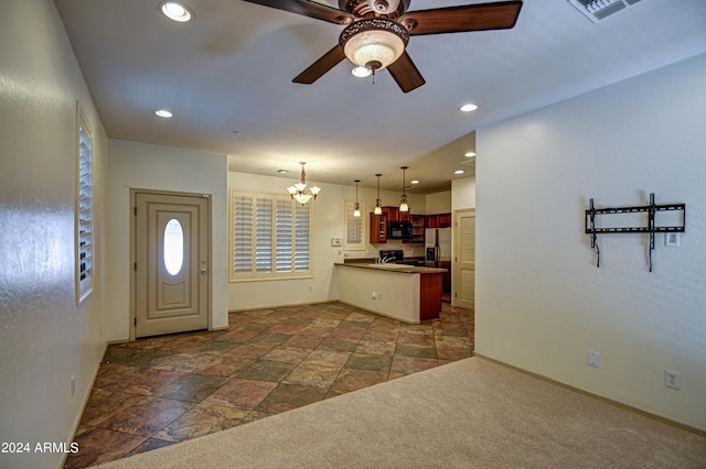 tiled entryway with ceiling fan with notable chandelier