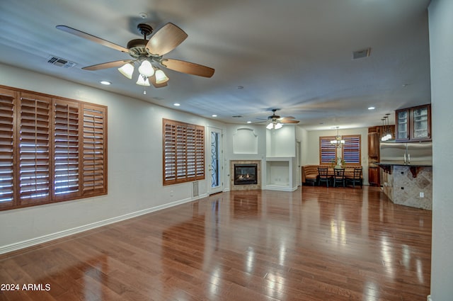 unfurnished living room featuring wood-type flooring and ceiling fan