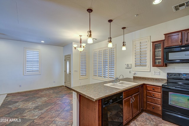 kitchen with dark tile floors, sink, black appliances, pendant lighting, and an inviting chandelier