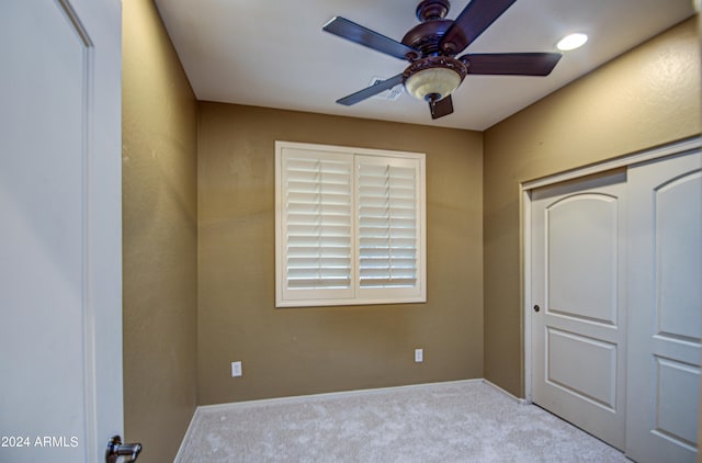 unfurnished bedroom featuring a closet, carpet floors, and ceiling fan