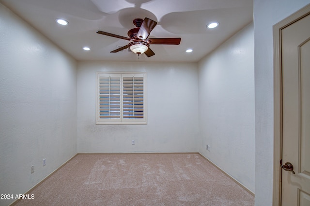 spare room with carpet floors and ceiling fan