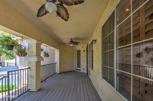 wooden deck featuring ceiling fan