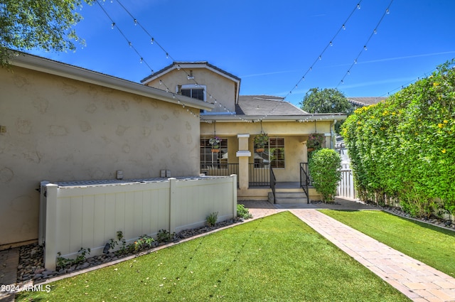 view of front of property featuring central AC unit and a front lawn