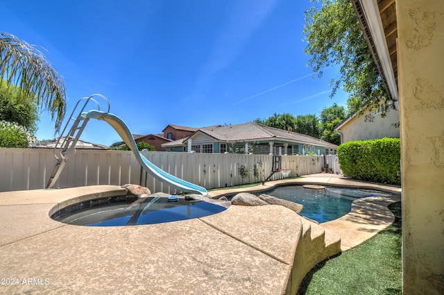 view of pool featuring a water slide and a patio area