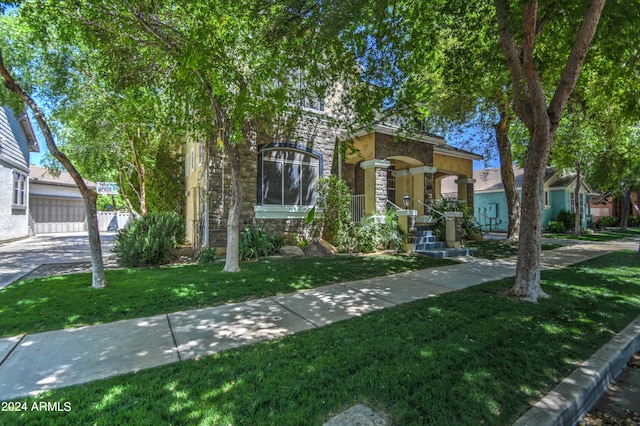 view of front of property with a garage and a front yard