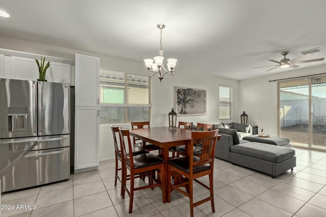 dining area with ceiling fan with notable chandelier, a healthy amount of sunlight, and light tile patterned flooring