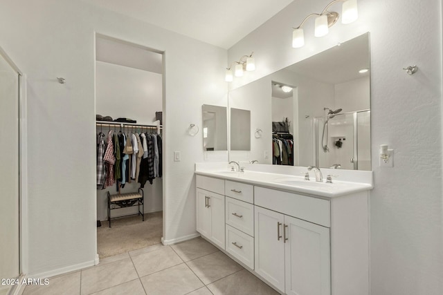 bathroom featuring vanity, tile patterned floors, and walk in shower