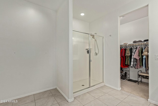 bathroom with tile patterned flooring and an enclosed shower