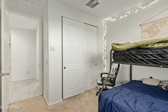 bedroom with light carpet and a closet