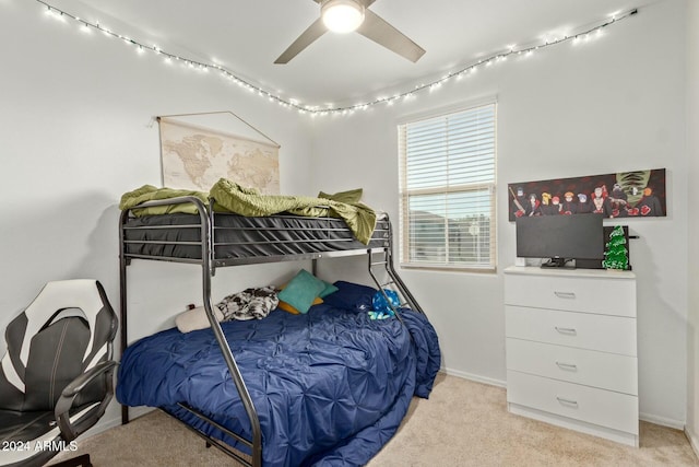 bedroom with ceiling fan and light carpet