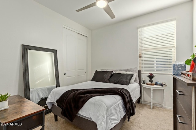 carpeted bedroom featuring a closet and ceiling fan