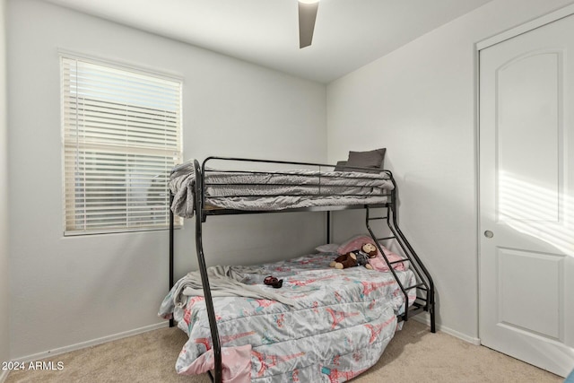 bedroom with light carpet and ceiling fan