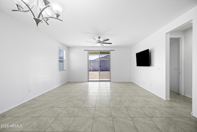 unfurnished room with light tile patterned flooring, ceiling fan with notable chandelier, and baseboards