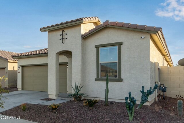 mediterranean / spanish home featuring a garage