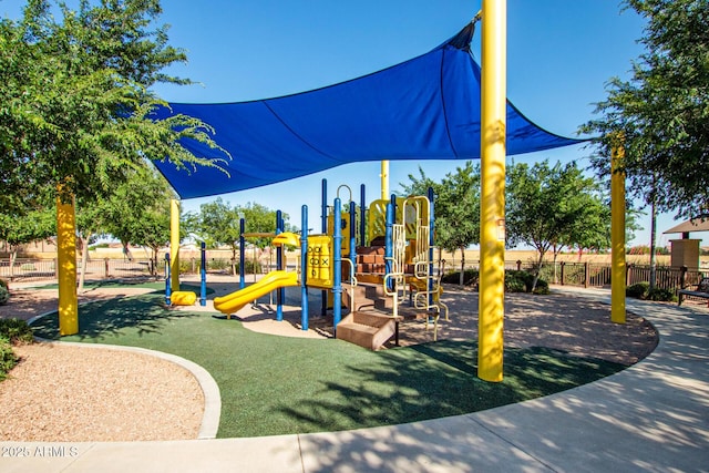 community playground with a lawn and fence