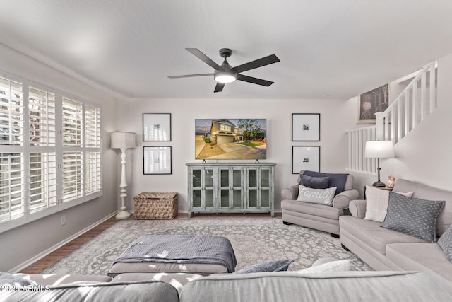 living room featuring wood-type flooring and ceiling fan