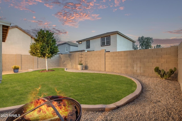 yard at dusk with an outdoor fire pit