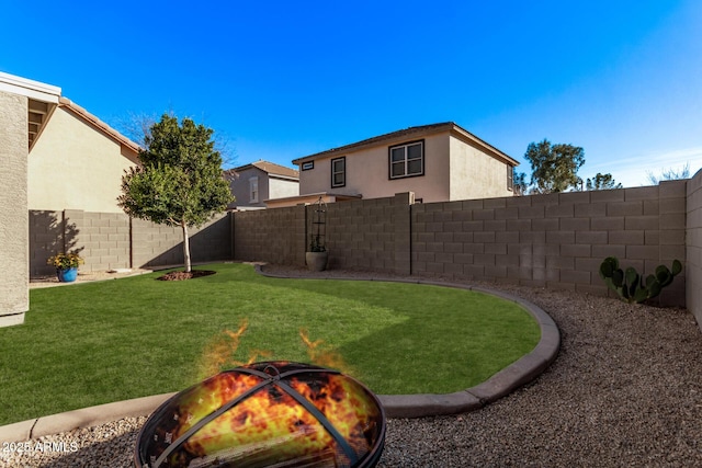 view of yard with an outdoor fire pit