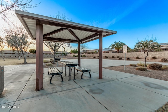 patio terrace at dusk featuring a gazebo