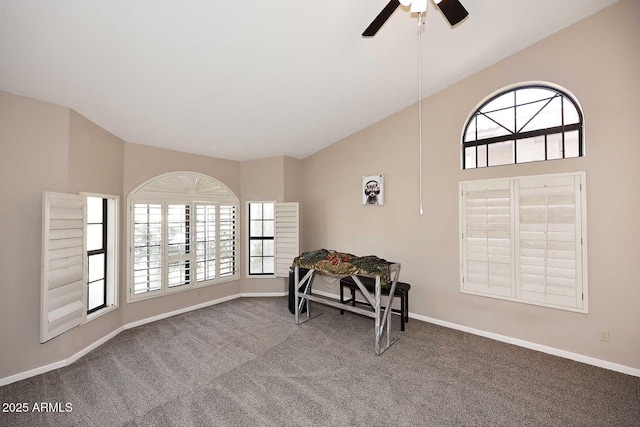 sitting room featuring lofted ceiling, carpet flooring, plenty of natural light, and baseboards