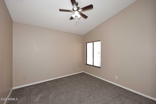 empty room featuring lofted ceiling, ceiling fan, baseboards, and dark colored carpet