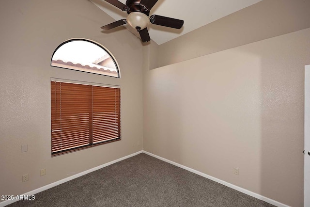 spare room featuring carpet floors, lofted ceiling, ceiling fan, and baseboards