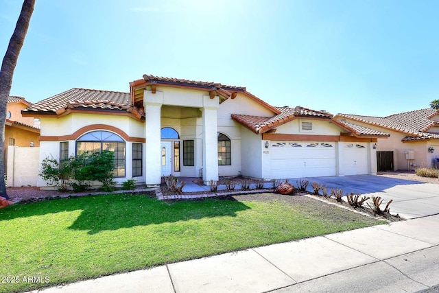 mediterranean / spanish-style house featuring a garage, a tile roof, concrete driveway, stucco siding, and a front yard