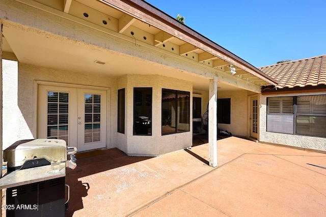 view of patio featuring french doors and a grill