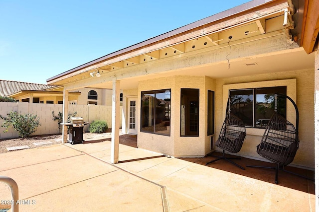 view of patio featuring fence and area for grilling