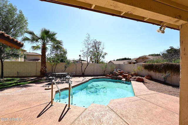 view of swimming pool featuring a fenced backyard, a fenced in pool, and a patio