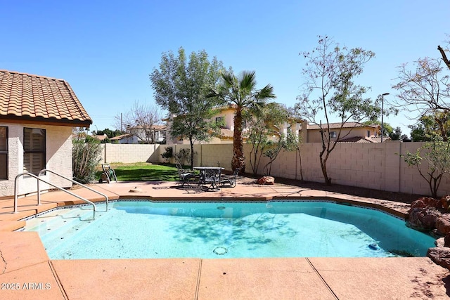 view of swimming pool with a fenced backyard and a patio