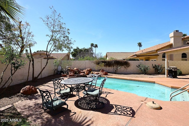 view of pool with a fenced backyard, a fenced in pool, and a patio