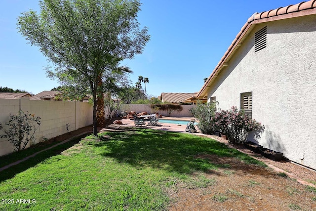 view of yard featuring a patio area, a fenced backyard, and a fenced in pool