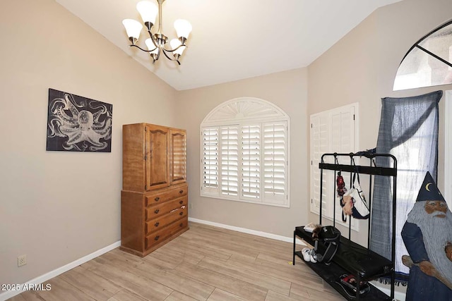 workout area featuring lofted ceiling, baseboards, light wood finished floors, and an inviting chandelier