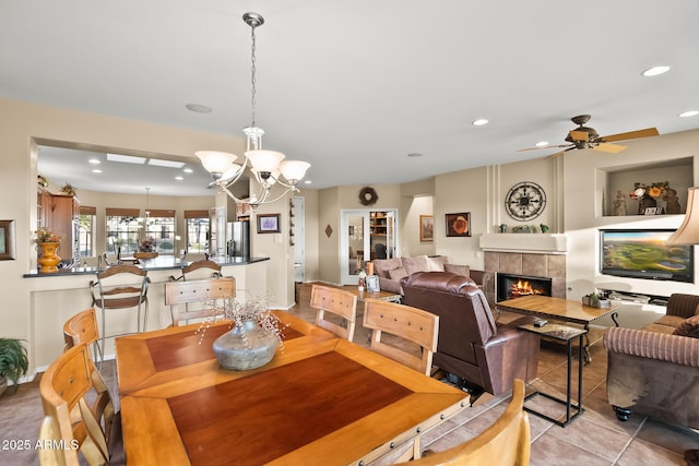 dining room featuring recessed lighting, a fireplace, and light tile patterned floors