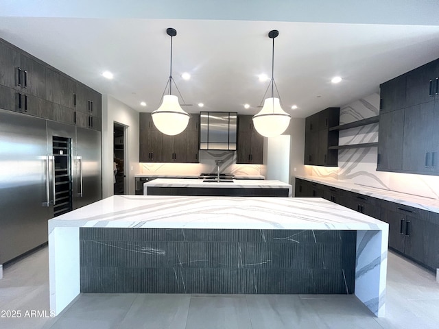 kitchen with decorative light fixtures, a center island, and backsplash