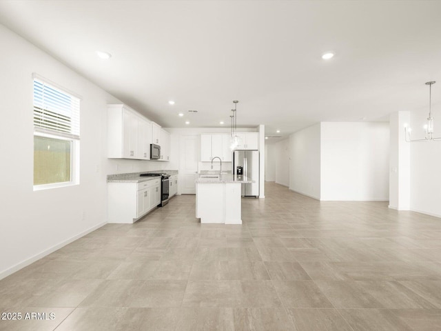 kitchen with an inviting chandelier, white cabinetry, an island with sink, stainless steel appliances, and hanging light fixtures