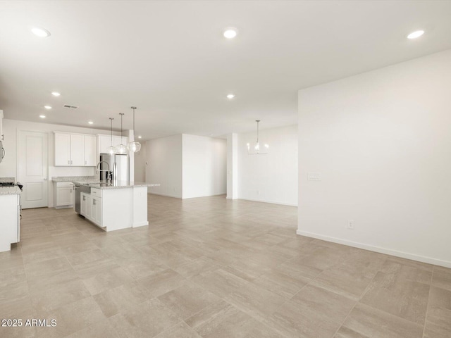 unfurnished living room with a notable chandelier